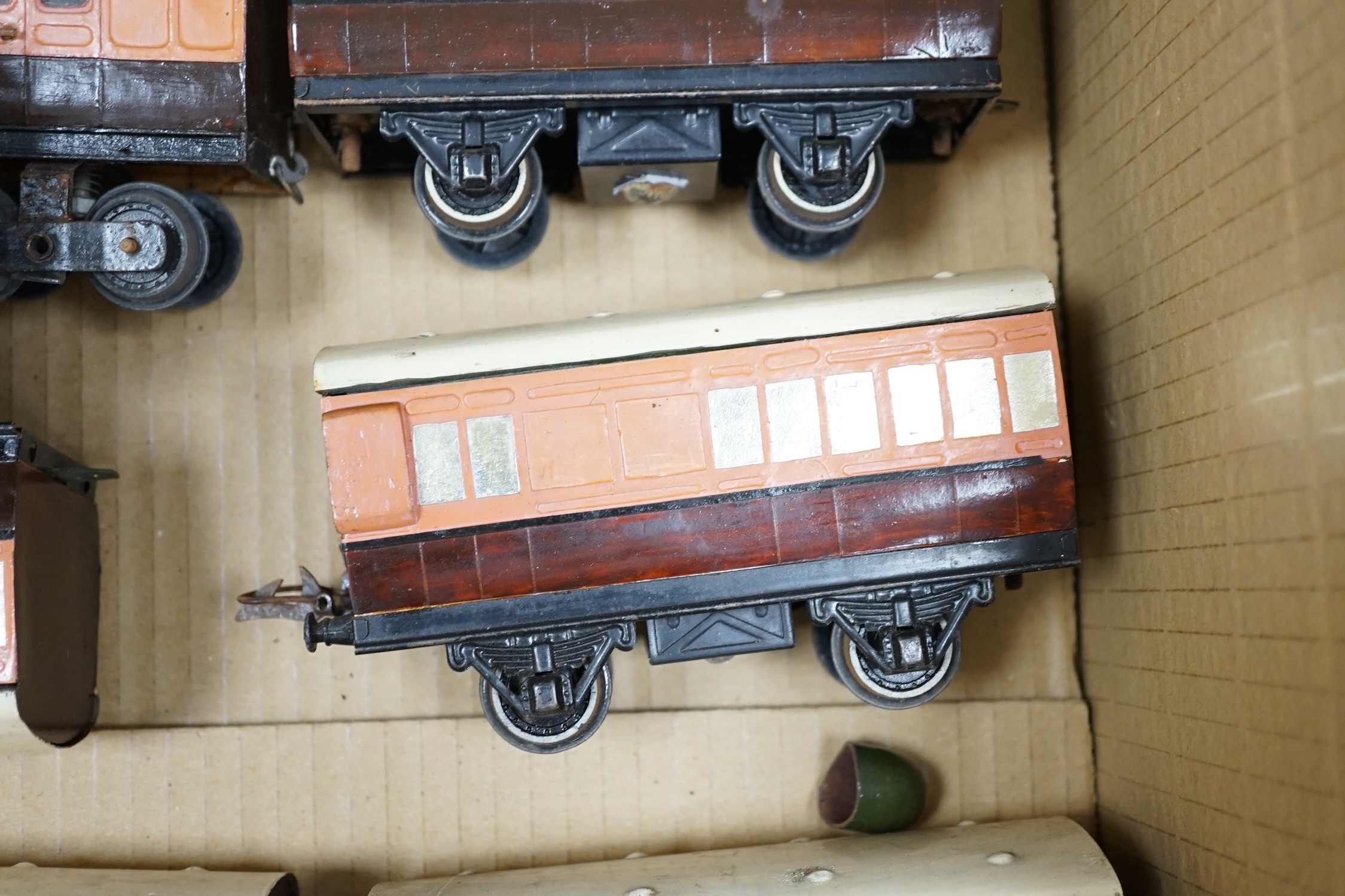 Fifteen tinplate 0 gauge railway items, including three clockwork locomotives; an LSWR 0-4-2 tender loco, an LSWR 0-4-0T and a SR 4-4-0T, all built using some commercial parts with some elements scratch built